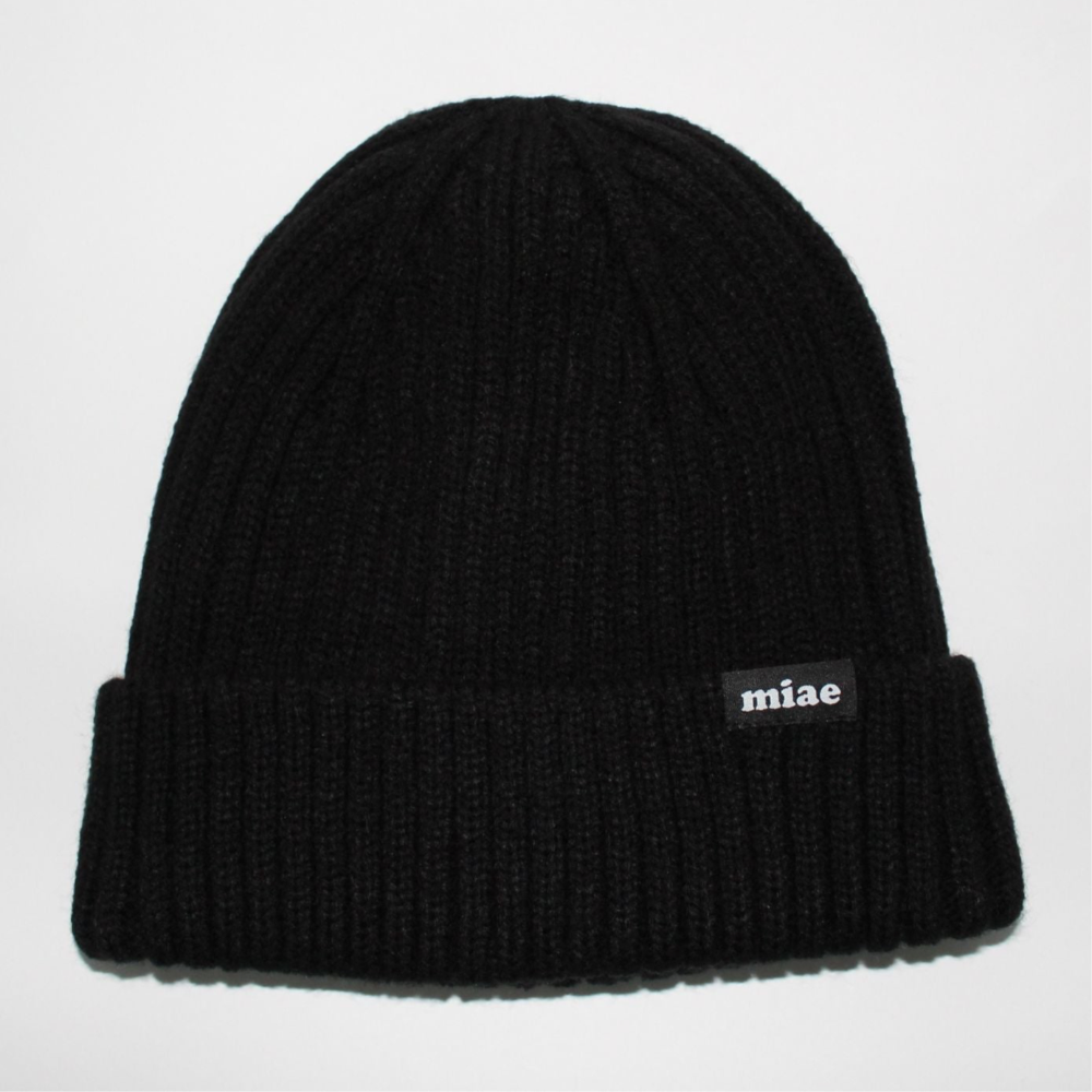 Flat lay of the Miae Black Satin-Lined Beanie, a soft and breathable hat designed to reduce frizz and retain moisture for natural, textured, and curly hair.