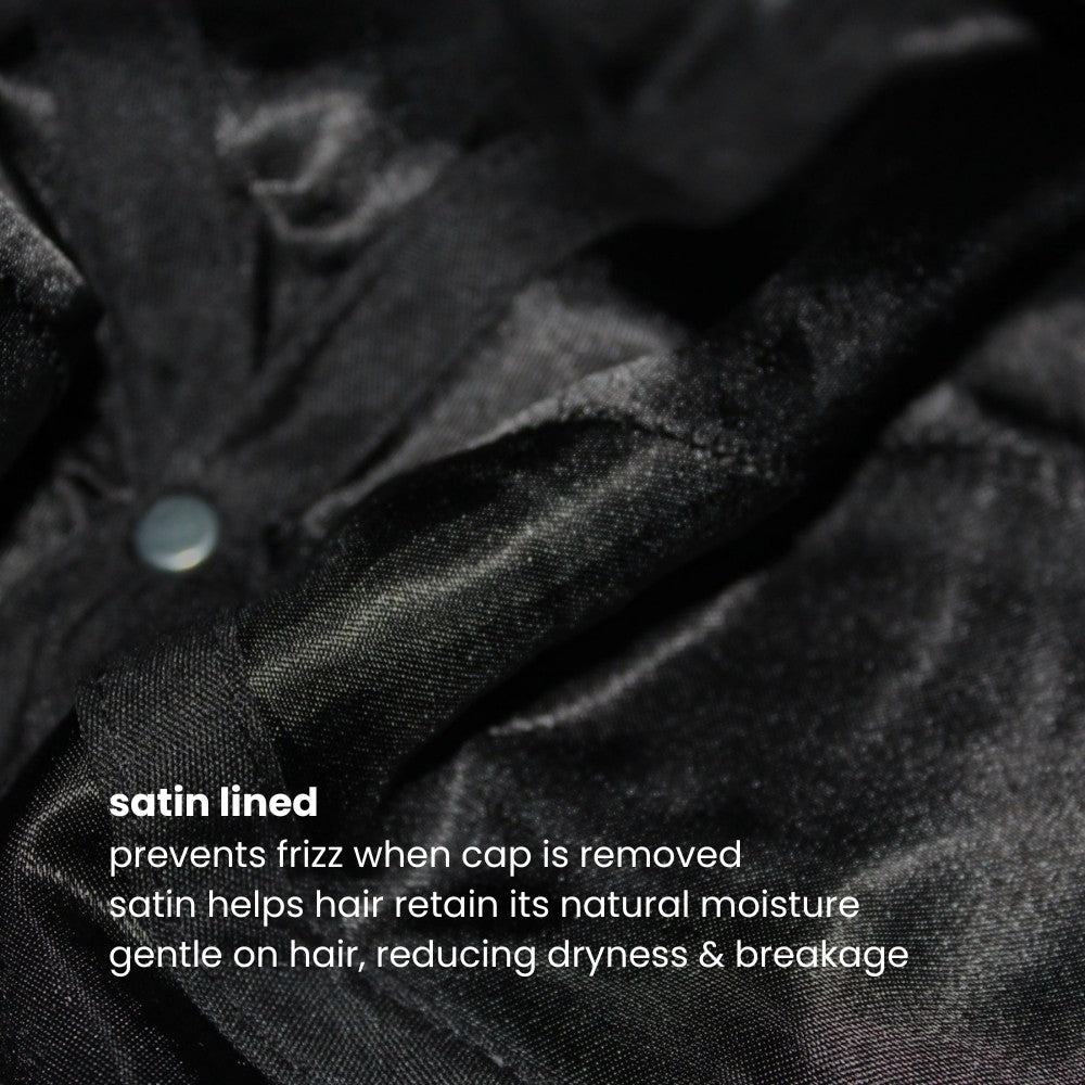 Interior satin lining of the Miae Charcoal Satin-Lined Cap, featuring text that explains how it prevents frizz, locks in moisture, and gently protects hair while complementing facial features.