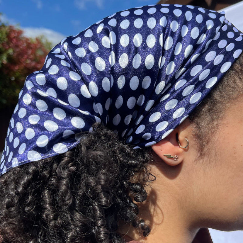 Side view of the Miae Blue Satin Hair Scarf with white polka dots, offering a gentle, frizz-reducing style for textured hair.
