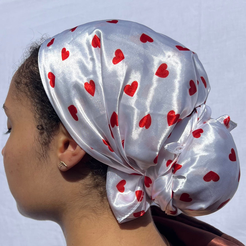 Curly hair styled with the Miae White Satin Hair Scarf with red love hearts, reducing frizz and breakage while maintaining a stylish look.
