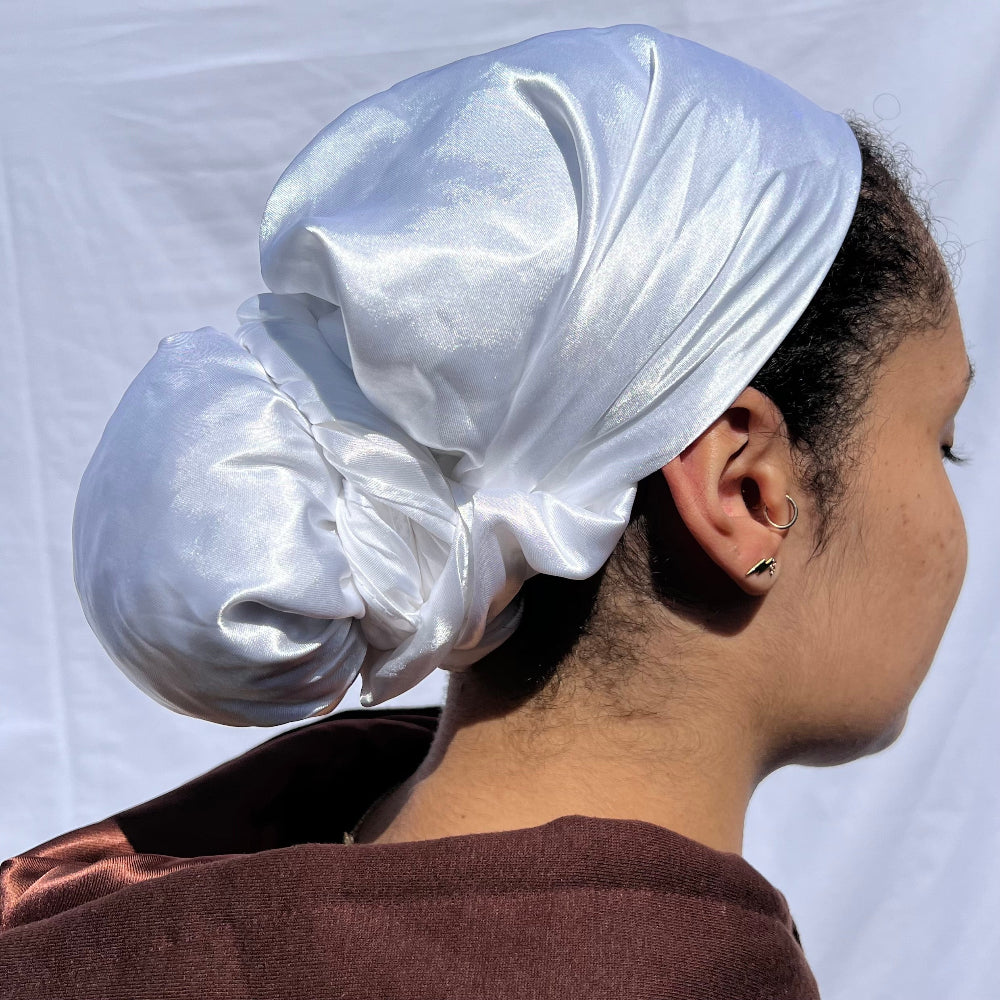 Model wearing the Miae White Satin Hair Scarf, gently styled over curly hair to protect against frizz and breakage.
