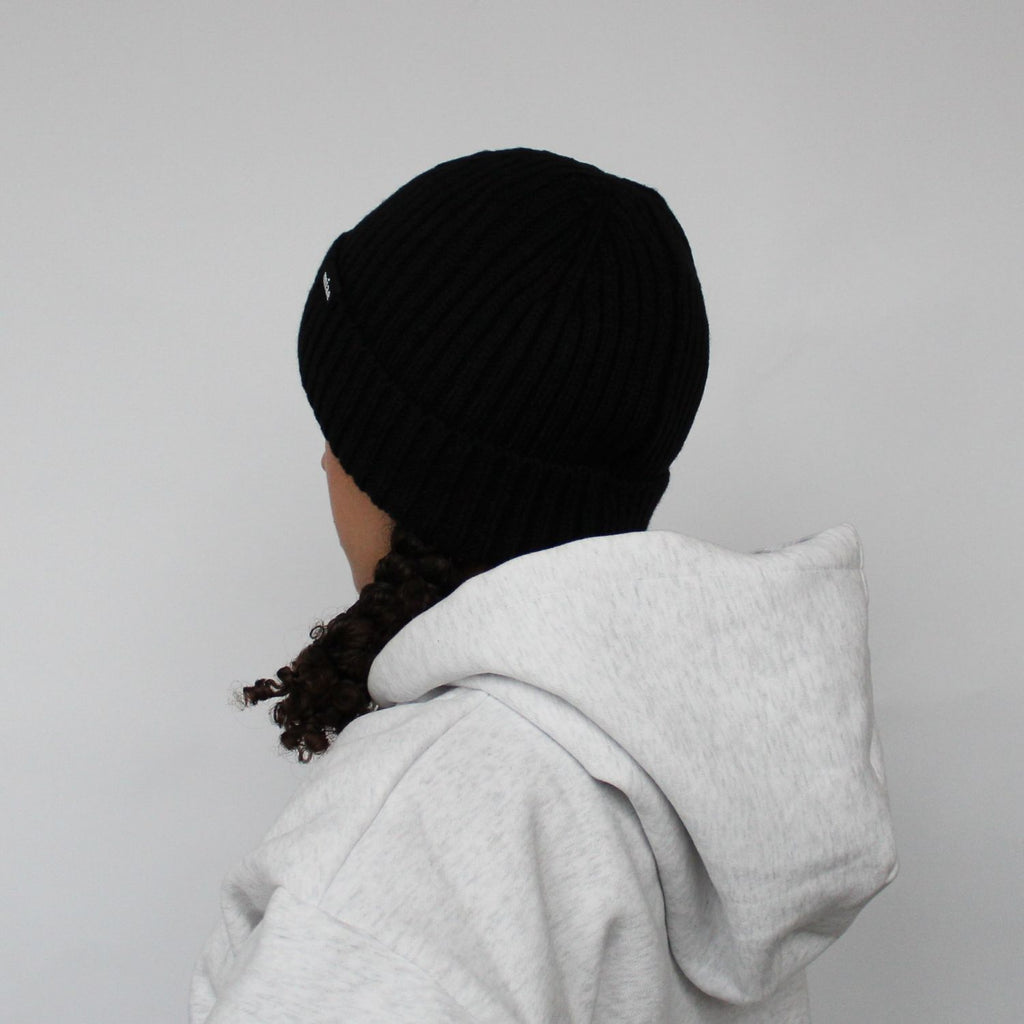 Back view of the Miae Satin-Lined Beanie in Black, offering a snug fit and smooth design to protect natural, textured, and curly hair