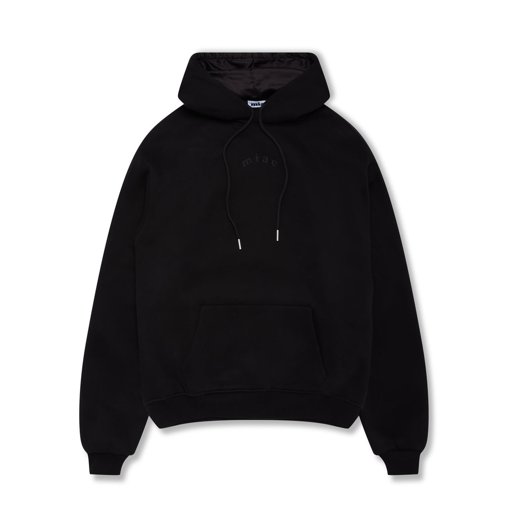 Flat lay of the Miae Black Satin-Lined Hoodie, showcasing a soft fleece fabric and satin-lined hood that helps reduce frizz and hair breakage.