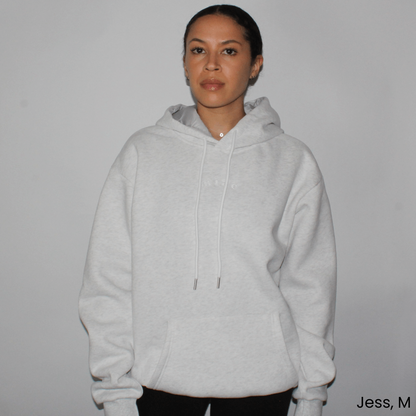 Model wearing the Miae Light Grey Marl Satin-Lined Hoodie, showcasing its relaxed fit and stylish satin-lined hood for hair protection.