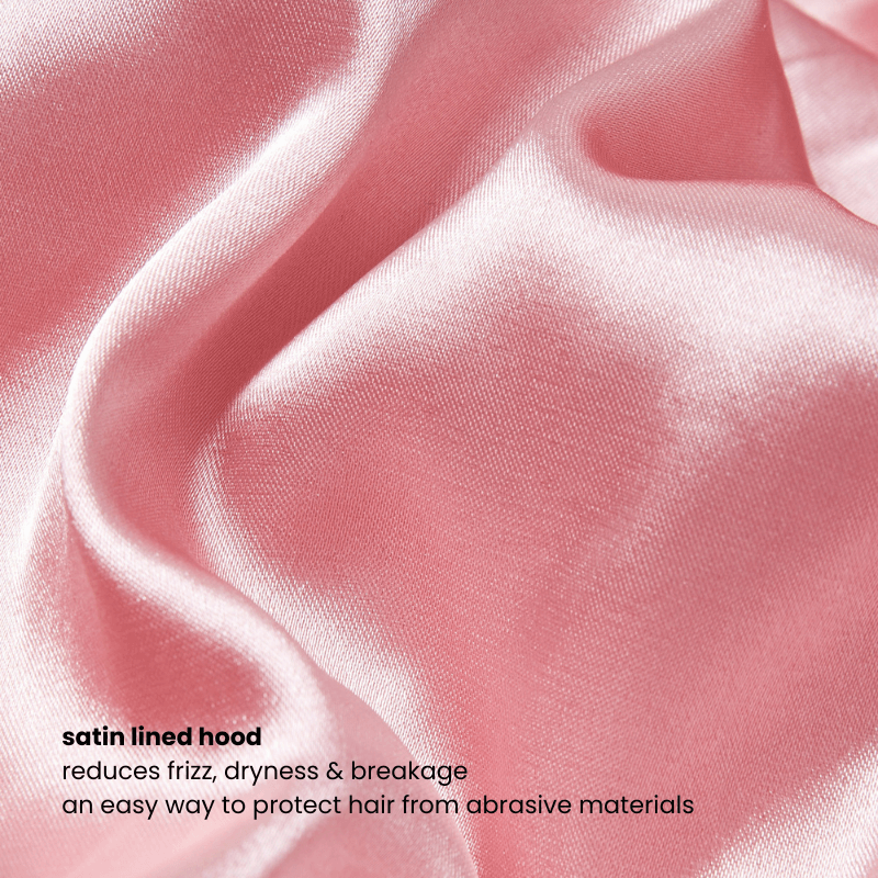 Close-up of the pink hoodie’s satin-lined hood, designed to reduce frizz, dryness, and breakage for textured and curly hair