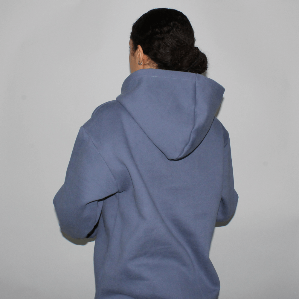 Back view of the Miae Washed Blue Satin-Lined Hoodie on a model, showcasing the sleek, flattering fit and satin-lined hood for frizz protection.