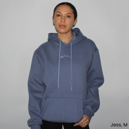Model wearing the Miae Washed Blue Satin-Lined Hoodie, offering a stylish and comfortable fit with a frizz-reducing satin-lined hood.