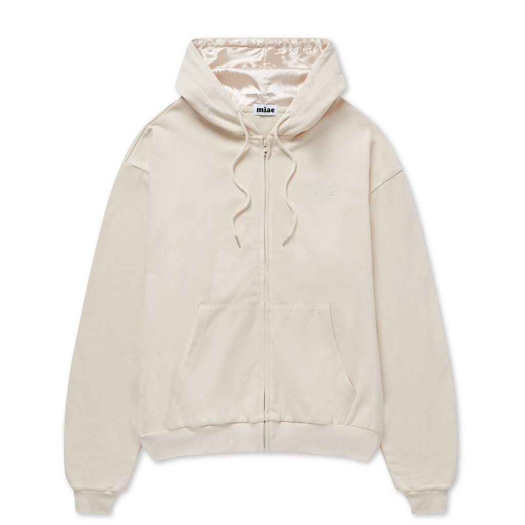 Flat lay of the Miae Beige Satin-Lined Zip Hoodie, featuring a soft cotton body and protective satin-lined hood for curly and textured hair