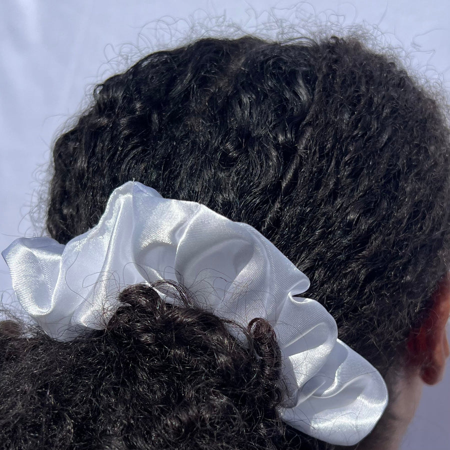 Model wearing the Miae White Satin Scrunchie in a ponytail, a smooth and stylish hair tie perfect for natural, textured, and curly hair.